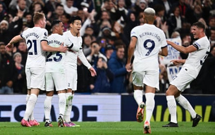 Son Heung-min is mobbed by his teammates after opening the scoring