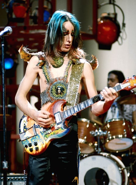Todd Rundgren when younger, playing guitar, with long blue hair