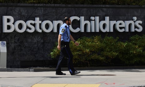 A public safety officer passes the sign at the entrance to Boston Children's Hospital in Boston.