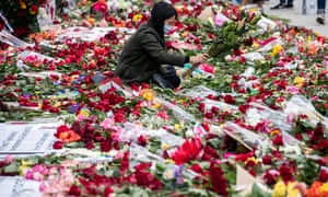 A protester lays down flowers in front of the Hall of Justice in Los Angeles, part of the ‘Rose From Concrete’ action inspired by a poem by late rapper Tupac Shakur, while hundreds continue demonstrating over the arrest and death in police custody of George Floyd.