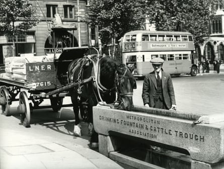 Horse-drawn and motorised traffic in London in the 1930s.