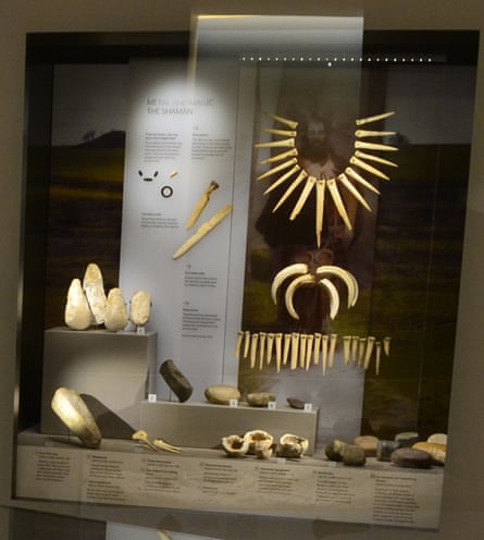 Artefacts in glass case including axe heads, tools and animal bones