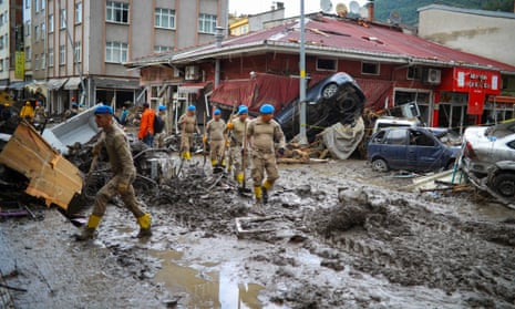Soldiers arrive to clear the debris after the Ezine River broke its banks during flash floods in Bozkurt in the Black Sea region of Turkey.