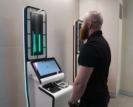 A person uses a EES kiosk