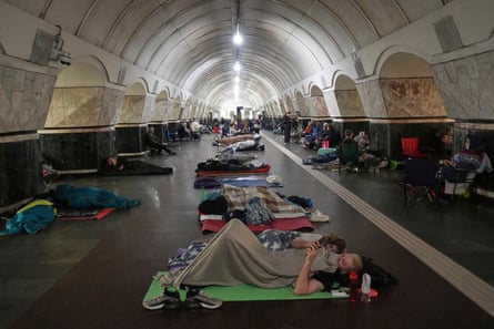 People rest in a metro station, being used as a bomb shelter, during the Russian attack on Kyiv