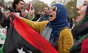 FILES-US-ARAB-DIPLOMACY-REVOLUTION
(FILES) In this file photo taken on April 9, 2011, Libyans sing a patriotic song in front of the White House in Washington during a protest by Libyans and Syrians against the regimes of Moamer Kadhafi and Bashar al-Assad. - Ten years ago as protests flared across the Arab world Western governments failed to meet a date with destiny and help nurture dreams of democracy, missing an unprecedented chance to shape real reform. History will not judge them kindly, say many of those who there and who talked to AFP on the 10th anniversary of the Arab Spring, about why a decade on its early promise has withered and mostly died. (Photo by Nicholas KAMM / AFP) (Photo by NICHOLAS KAMM/AFP via Getty Images)