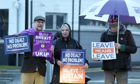Leave supporters wave banners in Belfast during a visit by Theresa May in February.