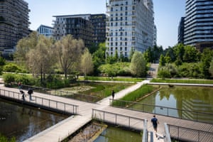 people by a pond divided into square sections below walkways