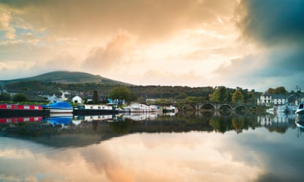 Moored barges and the seven-arch bridge across the Barrow River.