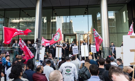 Police officers secure Uber HQ office building in London during a protest by Uber drivers