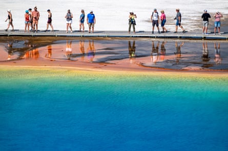 people walk along a hot spring
