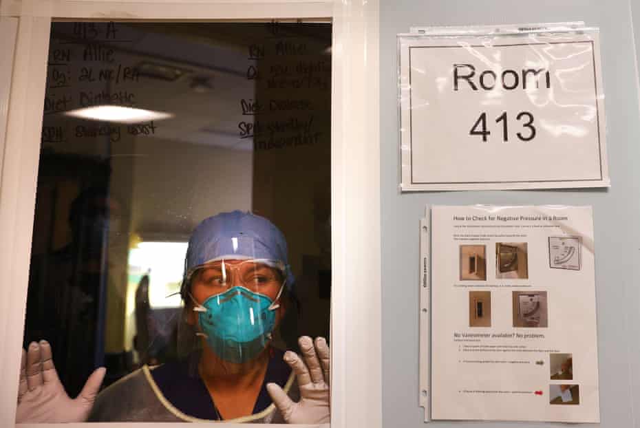 Nursing assistant Lizbeth Nieto looks out from a Covid-19 patient’s room at Sharp Coronado hospital on 14 December 2020 in Coronado, California.