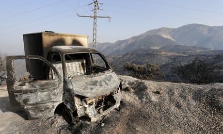 A charred truck in the aftermath of deadly fires in the Kabyle region