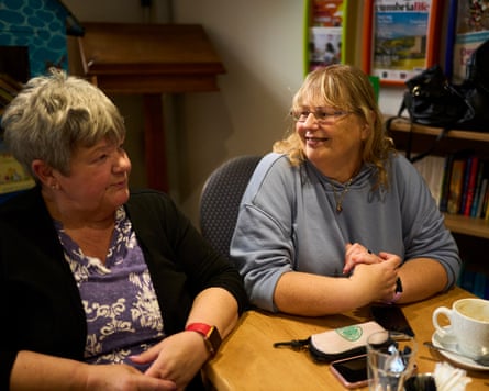 Susan Allen and Jane Southworth sitting side by side at a coffee table