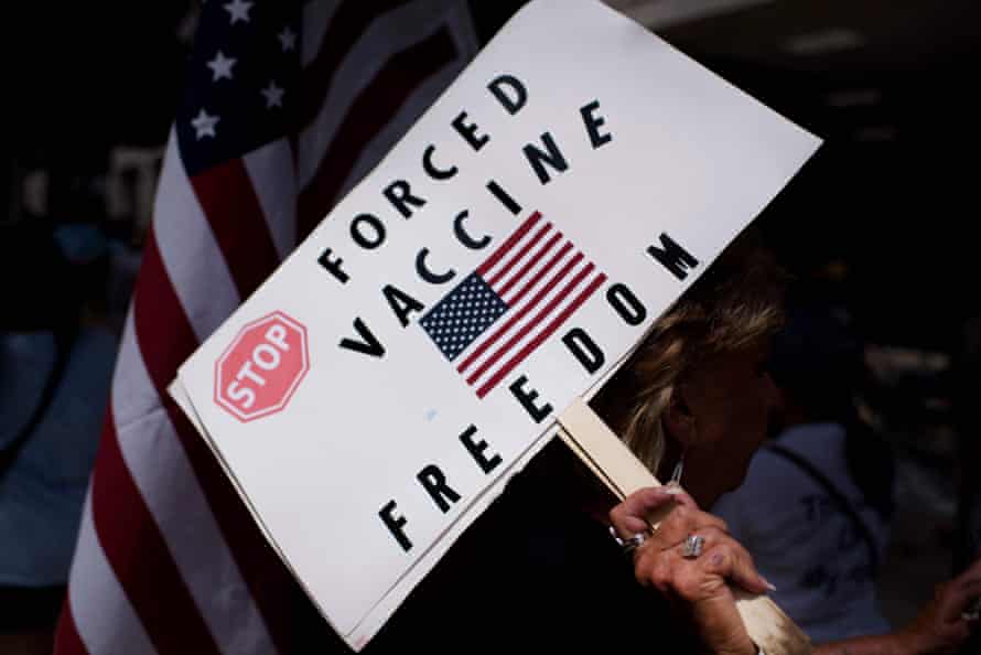 Anti-vaccine protesters hold signs outside of Houston Methodist hospital.