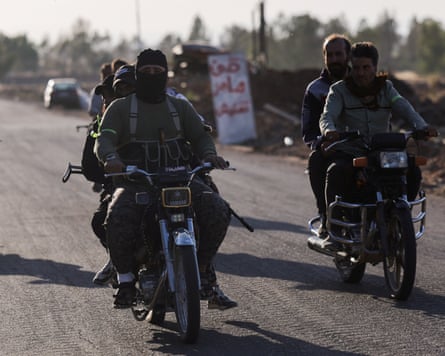 Armed Syrian Bedouin fighters riding motorcycles