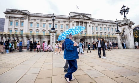 People walk past Buckingham Palace in London on Monday.