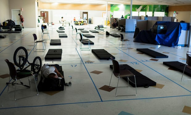 A man rests on a cot inside a cooling shelter during a heatwave in Portland, Oregon, last year.