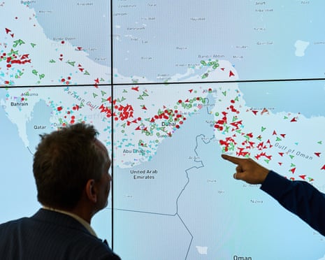 Hapag-Lloyd employees monitor the status of cargo ships in the strait of Hormuz in Hamburg, Germany