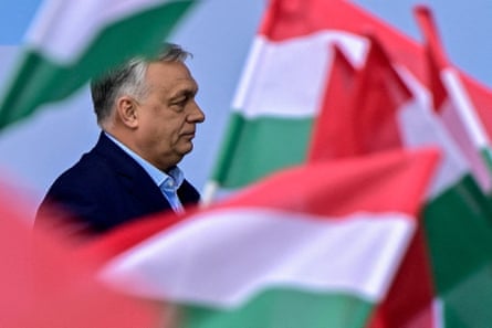 Orbán walks through waving Hungary flags