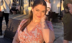 Maddy Lawrence, 20,  smiling in sunshine and wearing a dress patterned with small red flowers