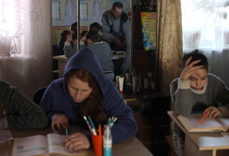 Ukrainian teacher Oleksandr Pogoryelov, 45, gives lessons to students in the living room of his house in Shandryholove, Donetsk region, earlier this week.