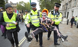 Police holding a protester during an Extinction Rebellion demonstration in central London in October 2019