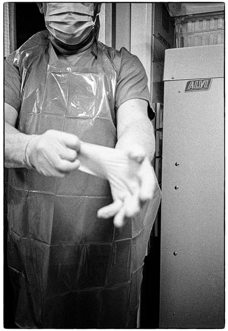 A staff member applies PPE at Nevill Hall hospital in Abergavenny