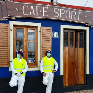 Men wearing masks and high viz jackets outside Peter Cafe Sport, Azores