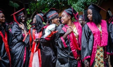 A group of smiling female graduates in the streets of Juba, South Sudan