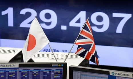 Japanese and British flags in front of computer screen