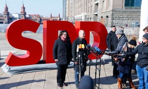 Andrea Nahles (L) and Olaf Scholz of Social Democratic party (SPD) give a press statement in Berlin.