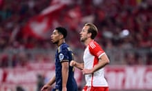 Real Madrid's Jude Bellingham, left, runs with Bayern's Harry Kane during the Champions League semifinal first leg soccer match between Bayern Munich and Real Madrid at the Allianz Arena in Munich, Germany, Tuesday, April 30, 2024. (AP Photo/Christian Bruna)