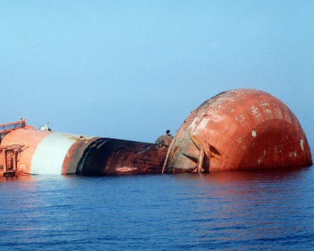 A large leg of a rig on its side in the sea.