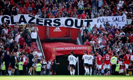 Manchester United fans display a banner in protest against the ownership of the club saying ‘Glazers out’.