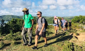 A group hiking on a hill in the sunshine