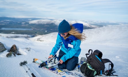 The author prepares her ‘split’ board ready to snowboard down the mountain