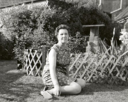 Bowie’s mother, Margaret Mary Jones, sitting on a lawn with a garden behind her