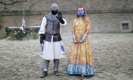 Actors wearing protective masks pose after a rehearsal at Le Puy du Fou before its reopening in June.