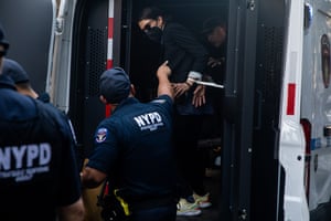 police load a woman into a van