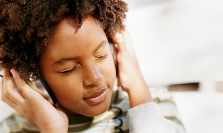 Young Woman With Her Eyes Closed Listening to Music on Headphones