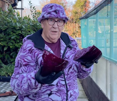 Gerald Stratford holding a dissected red cabbage and wearing a red-cabbage-patterned fleece and bucket hat