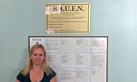 Patricia Guzman stands in front of the plaque commemorating worker takeover of the hotel.