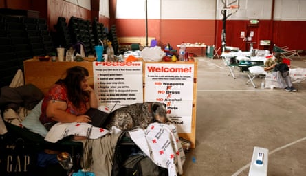Jack Romero shares her cot with her dog Rascal at a Dixie fire evacuation center run by the Red Cross in Quincy.