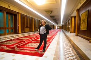 A woman talks on her mobile phone on one of the halls of the Romanian Parliament building, in Bucharest.
