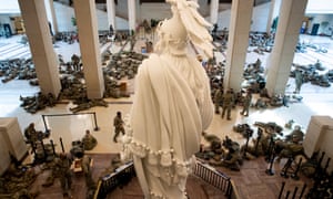 Hundreds of US National Guard troops rest in the US Capitol Visitors Center, with the Statue of Freedom seen at center, on Capitol Hill in Washington, DC, today.At least ten thousand troops of the National Guard will be deployed in Washington by the end of the week, with the possibility of five thousand more, to help secure the Capitol area ahead of more potentially violent unrest in the days leading up to the inauguration of Joe Biden on January 20.