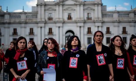 Activists hold portraits of people disappeared during the Pinochet dictatorship as they protest in front of La Moneda presidential palace in 2019.