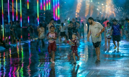 Kids take part in a water gun battle during the Songkran celebration.