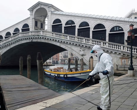 A worker sanitises the Rialto bridge in Venice.