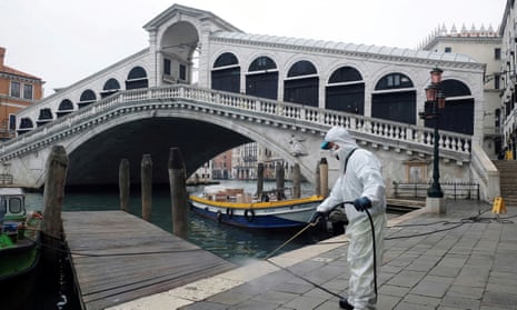 A worker sanitises the Rialto bridge in Venice.